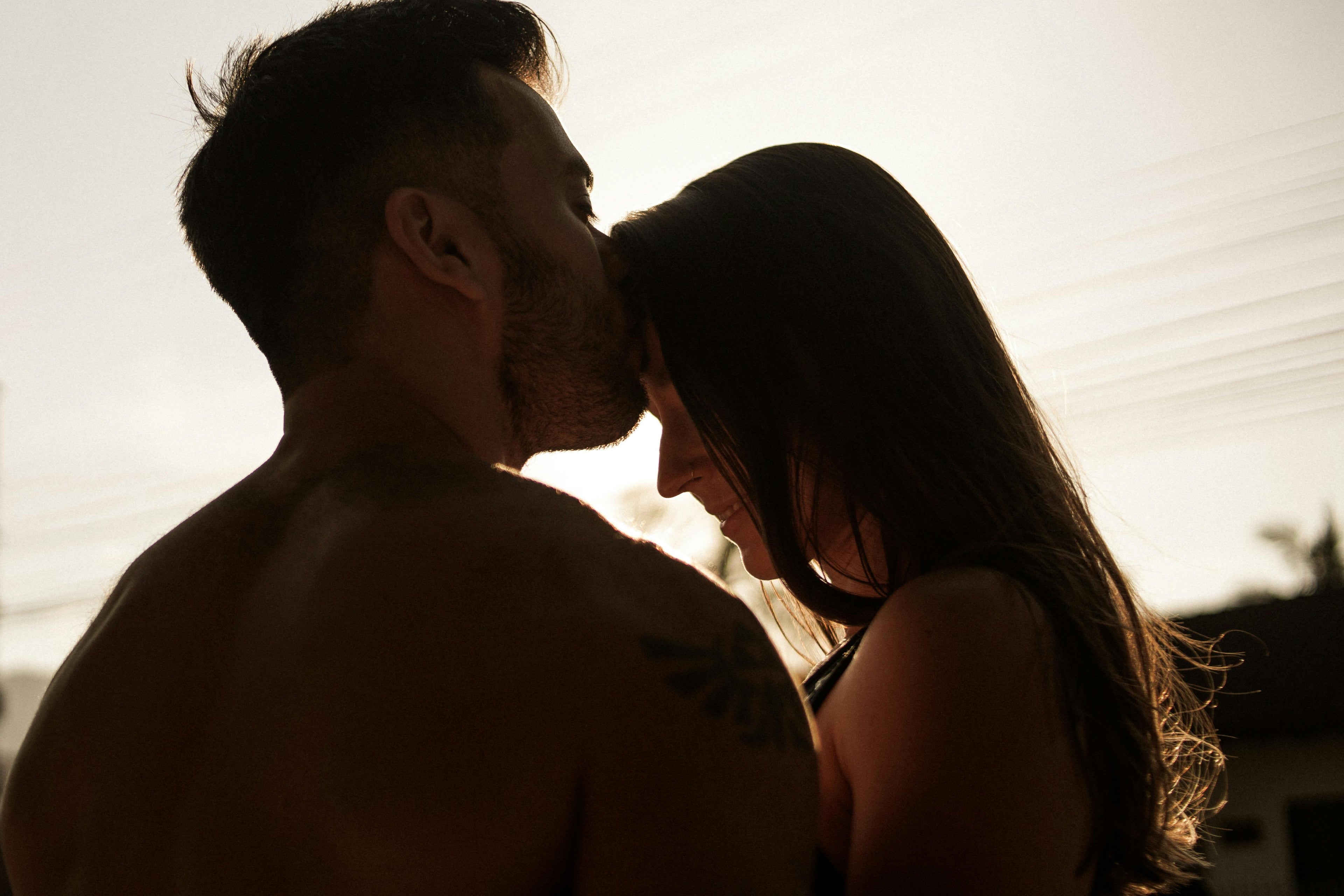 Silhouette of a couple embracing with a warm glow