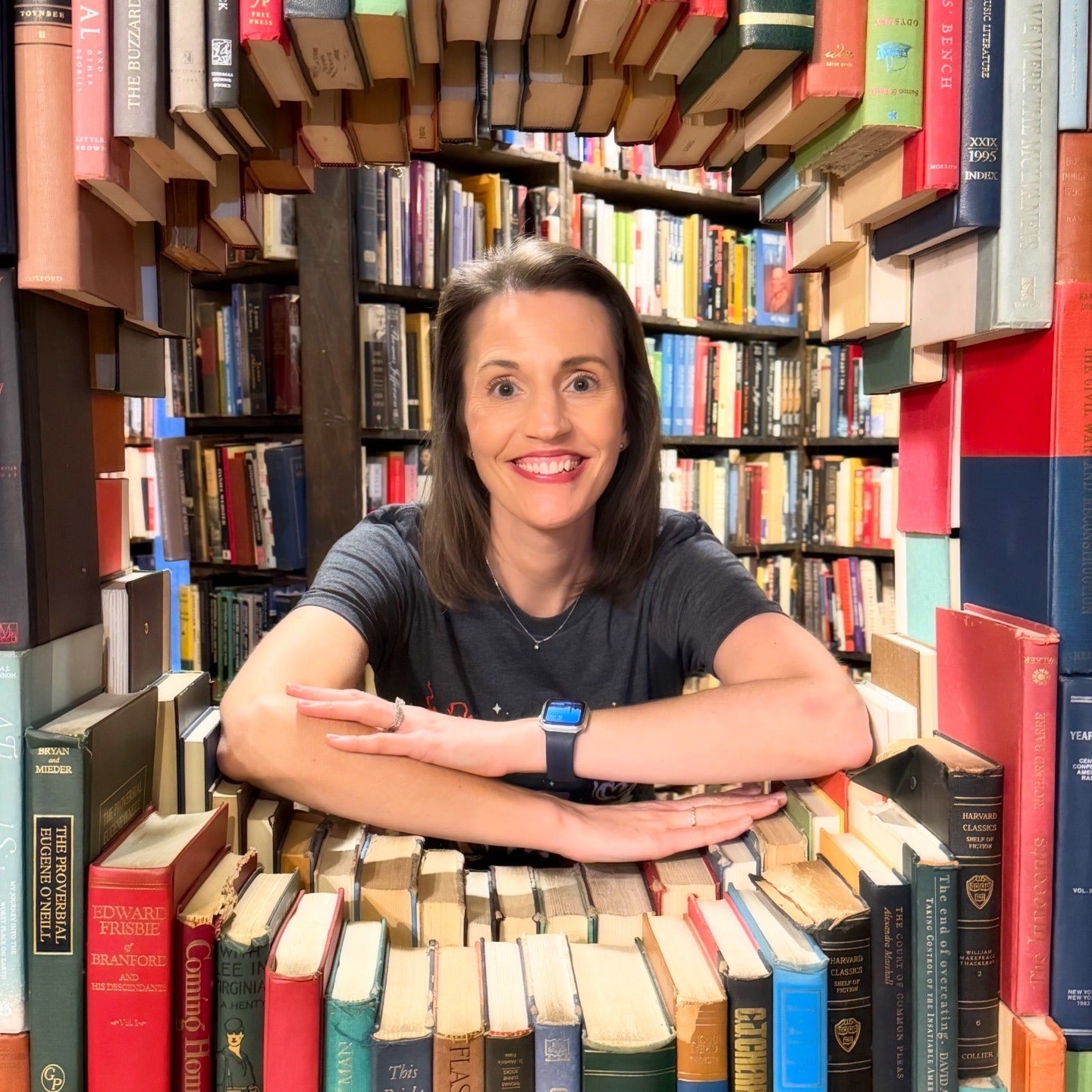 Author Stephanie Riley surrounded by books